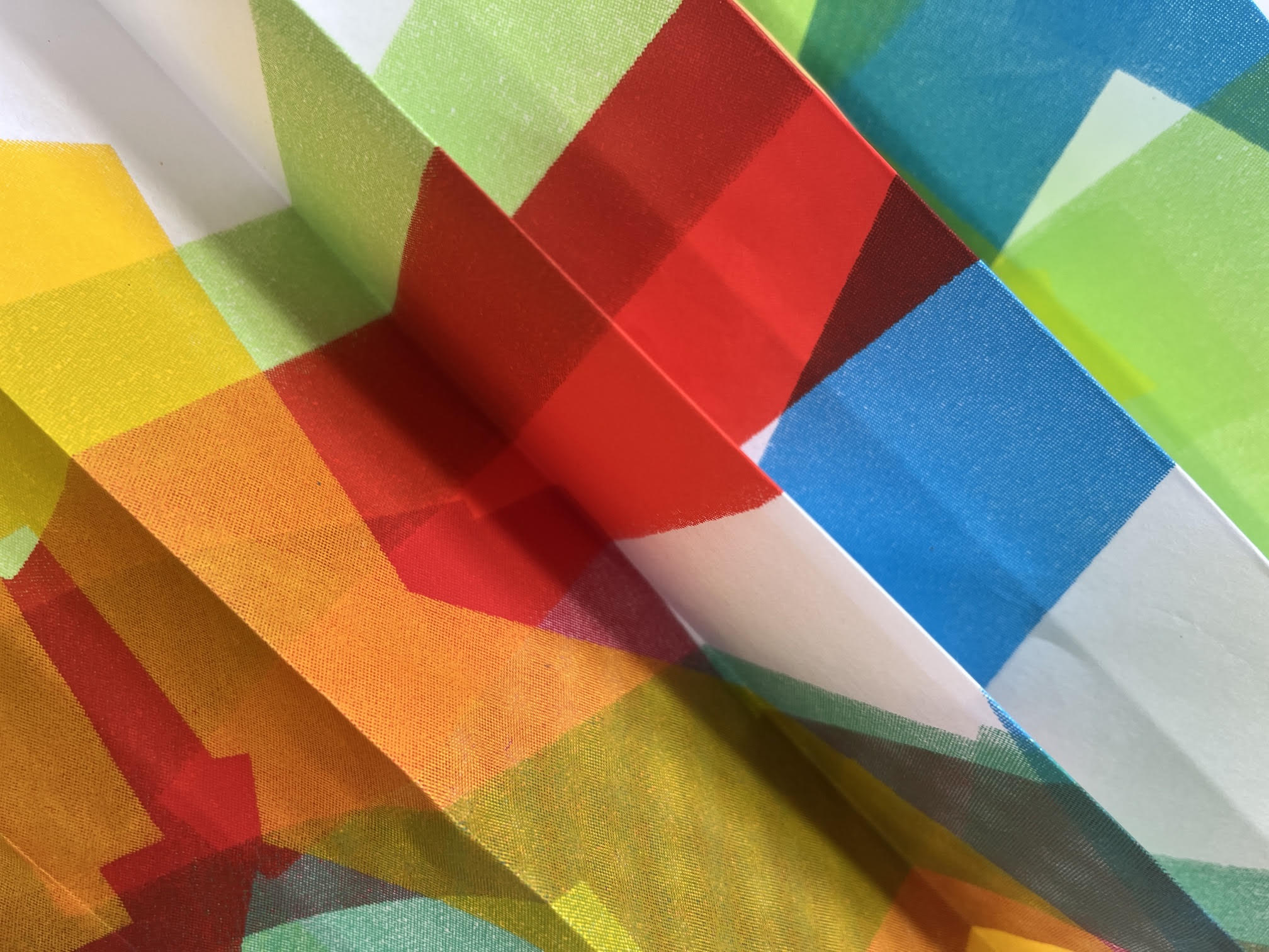 detail shot of colourful concertina'd paper